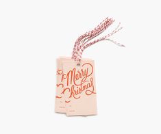 a christmas tag hanging from a string on a white background