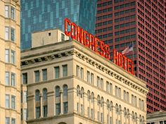 the congress hotel sign is on top of an old building in new york city's financial district