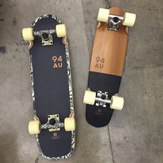 two skateboards sitting next to each other on the ground