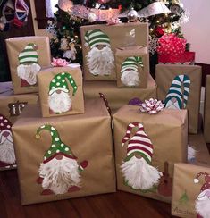 christmas presents wrapped in brown paper with santa hats and beards on them