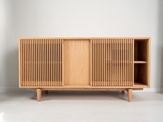 a wooden cabinet sitting on top of a white floor