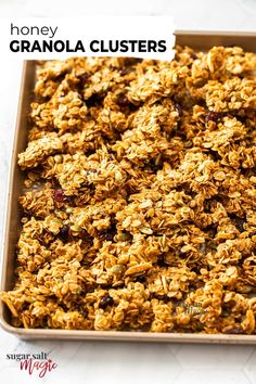 granola clusters in a baking pan with the words honey granola clusters above it