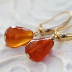 Treat yourself or a loved one with these gorgeous drop earrings. Made with lovely Carnelian stones and a contemporary design to go with your evening and daytime looks. These Carnelian earrings for women are made stunning with the combination of gold and orange color of stone. Wear and style with other 14k jewelry pieces. Product Details: --------------------- Material - Gold plated over brass (Nickel-free) Measurements: Length of the whole earring - 0.9 ''/2.2 cm. Why purchase this pair of Pomeg Elegant Carnelian Earrings For Gift, Elegant Carnelian Earrings Gift, Carnelian Teardrop Earrings For Gift, Elegant Carnelian Drop Earrings, Elegant Carnelian Dangle Earrings, Gold Carnelian Dangle Earrings, Elegant Carnelian Teardrop Earrings, Carnelian Drop Earrings With Natural Stones, Gold Carnelian Gemstone Earrings