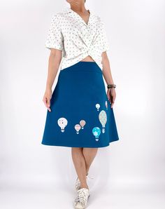 This playful and versatile skirt is designed with whimsical hot air balloon sew-on appliques that add a touch of charm and adventure to your outfit. Made with stretchy fabric, this plus-size skirt offers a comfortable and flattering fit for all-day wear. The fold-over waistband adds an extra element of comfort and flexibility, allowing you to adjust the fit to your liking. Whether you're strolling through the city or attending a casual gathering, this skirt is perfect for adding a pop of fun and Whimsical Hot Air Balloon, Skirts Hot, Jersey Knit Skirt, Hot Air Balloon Decorations, Elastic Waistband Skirt, Hot Air Balloon Ride, Fold Over Elastic, Stretchy Skirt, Jersey Skirt