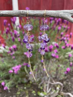 "One of my favorite flowers is the hanging wisteria. Their color is somewhere in the area of light lavender to deep purple, making amethyst a perfect gemstone choice to mimic it! These earrings are made with both Brazilian lavender amethyst and African dark purple amethyst, with faceted rondelles and step-cut gems in a cascade down 14K gold-filled chain. If you prefer sterling silver or 14K rose gold-filled, simply select in the drop-down menu! These are 3.25\" long, and will be gift-boxed at pu Bohemian Purple Dangle Crystal Earrings, Handmade Amethyst Purple Earrings, Purple Long Drop Earrings With Ear Wire, Purple Spiritual Drop Earrings, Purple Amethyst Earrings For Pierced Ears, Spiritual Purple Drop Earrings, Purple Amethyst Spiritual Earrings, Purple Amethyst Jewelry For Pierced Ears, Spiritual Purple Amethyst Earrings