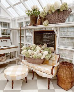 a room filled with furniture and flowers in baskets on top of it's shelves