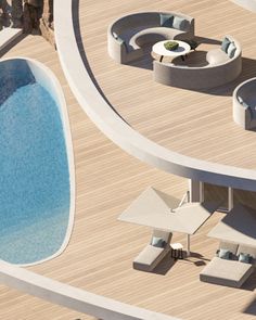 an aerial view of a swimming pool with lounge chairs and tables next to the pool