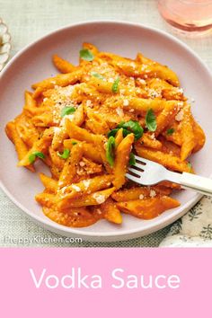 a white plate topped with pasta covered in sauce