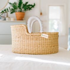 a wicker basket sitting on top of a bed