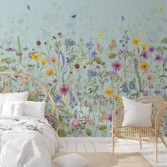 a bedroom with flowers painted on the wall and a wicker chair next to it