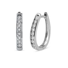 Level up your style with this stunning pair of diamond hoop earrings. Crafted in sterling silver, these huggy hoops are lined with sparkling round cut diamonds, artfully set with miracle plates. Radiant with 1/10 ct.t.w. of diamonds and a brilliant buffed luster, these diamond huggies earrings are secured by hinged backs. Product Specification: Product Dimension : 20.20 mm (Length) x 3.60 mm (Width) x 15.70 mm (Depth) Earring Type : Huggie Hoop Earring Style : Single Row Diamond Accent Closure T Huggies Hoop Earrings, Diamond Huggies, Dimension 20, Hoop Earrings Style, Diamond Hoop Earrings, Earring Type, Huggie Hoop Earrings, Diamond Clarity, Silver Diamonds