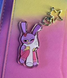 a pink and purple bag with a cartoon character on it's side, sitting in front of a star