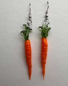 Handmade borosilicate glass carrot earrings. Approximately 3 inches long very lightweight on silver earwires. Comes with plastic backers. Stay rooted. Perfect for gardeners, veg-heads, and those who love to wear unique jewelry! The veggie series is inspired by my passion for gardening, which strides into my passion for growth, care and patience.  Each pair is made with love in Corning NY.  Thanks for looking<3 Vegetable Jewelry, Carrot Vegetable, Carrots, Jewelry Earrings Dangle, Dangle Drop Earrings, Dangle Earrings, Jewelry Earrings, Etsy Accessories, Accessory Gift