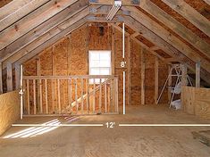 an attic with wooden walls and exposed rafters on the ceiling is being built for storage