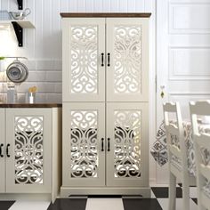 a kitchen with white cabinets and black and white checkerboard flooring in it