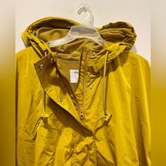 Old Navy Long Active Rain/Windbreaker Jacket Mustard Yellow In Color Size: Xxl Adjustable Straps Hood, Zipper And Push Buttons Netting Material Inside Warm, Comfortable Can Be Worn Oversized Worn 2x, Used, Like Brand New Mustard Outerwear For Fall Outdoor Activities, Mustard Outerwear For Fall Outdoor, Hooded Yellow Outerwear For Fall, Hooded Mustard Outerwear For Fall, Mustard Hooded Outerwear For Fall, Yellow Windbreaker With Pockets For Fall, Fall Yellow Windbreaker With Pockets, Casual Mustard Outerwear For Outdoor, Hooded Yellow Raincoat For Fall