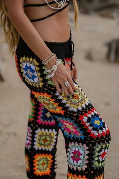 These boho essential pants in a granny square design, add effortless edge to any look. Specs: Handmade with love High rise ONE SIZE Elasticated waist Material: Polyester, Acrylic Colorful Bohemian Beach Bottoms, Bohemian Black Pants For Beach, Black Bohemian Beach Pants, Bohemian Black Beach Pants, Colorful Bohemian Summer Pants, Multicolor Bottoms With Elastic Waistband For Festival, Multicolor Festival Bottoms With Elastic Waistband, Black Hippie Beach Bottoms, Granny Square Pants Pattern