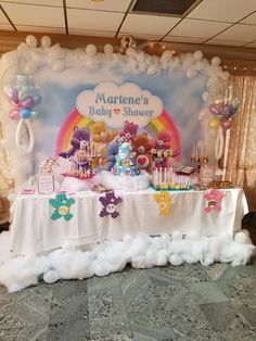 a baby shower party with teddy bears, balloons and cake on a table in front of a backdrop