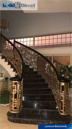 an elegant staircase with black marble steps and gold railings