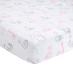 a white sheet with pink and grey swans on it's bottom half is shown