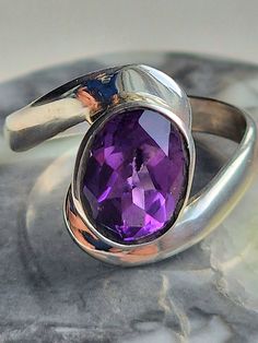 Sterling silver 925 ring - amethyst faceted (really shiny)  oval stone with simple wrap around setting - stunning ring - very comfortable and light to wear, and combine well with other jewellery.   AAA quality silver and crystals.    This ring comes gift wrapped and would make an ideal birthday gift, Valentine's Day Gift, Mother's Day Gift, anniversary gift or for any occasion. Amethyst is said to be the bridge that connects the concrete with the divine - the meaning of Amethyst has long been sy Pisces Birthstone, Oval Amethyst Ring, Ring Purple, Aquarius Pisces, Purple Crystal, 925 Ring, February Birthstone, Purple Crystals, Oval Stone