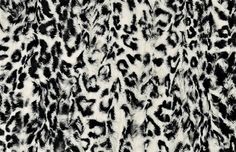 an animal print fabric with black and white spots on the top, as if it were fur