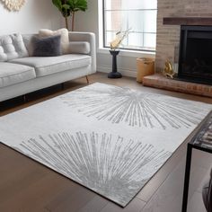 a living room with white furniture and a fireplace