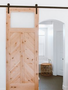 an open wooden door in a white room