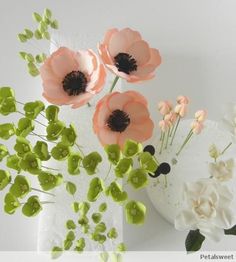 some flowers are sitting in a vase on a table