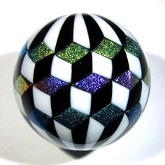 a black and white checkered ball with multicolored glitters