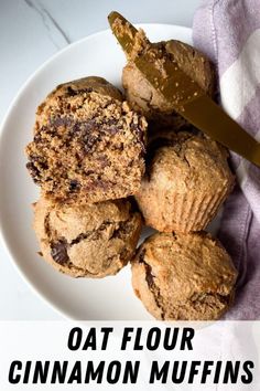 a white plate topped with muffins next to a knife