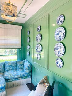 a green room with blue and white furniture