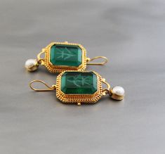 Description Gemstone -Green Glass Material - Brass Gemstone Size - 18X13 mm Earring Height Including Hoop - 5 cm Earring Width - 2 cm Finish - Smooth and high polished with brilliant shine. Natural stones may vary slightly in shape, size and color.Handmade Item You will receive the same piece as in the picture or identical. Since all gemstones are different from each other, I cannot guarantee that the gemstone you see above will still be available.. But I assure you will get same quality piece as shown in the above picture.# Your order will be dispatch within 3-5 working days after receiving order# Items will be sent via registered airmail and take approx. 15-20 days to arrive. #Express mail Via FedEx/DHL/Aramex, is available for an extra charge at checkout. Antique Jeweled Earrings For Gift, Rectangular Gemstone Earrings For Wedding, Antique Gemstone Earrings For Wedding, Jewlery Rings, Silver Jewlery, Antique Vintage Jewelry, Printed Dress Shirts, Cotton Blends Dress, Linen Shirt Dress