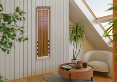 a living room filled with furniture and a potted plant