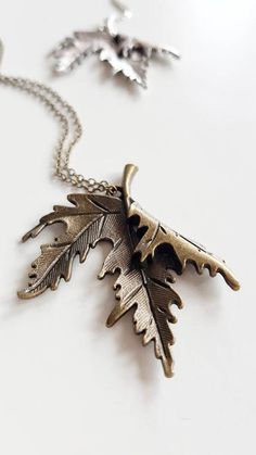 Statement Leaf Necklace, perfect for nature lovers in silver or bronze finish { D e s c r i p t i o n } The centerpiece of the necklace is a Canadian maple leaf pendant, which is known for its iconic and recognizable shape. The pendant is beautifully crafted with attention to detail, with every vein of the leaf captured.  The pendant is available in either a silver or bronze finish, allowing you to choose the color that best complements your personal style. The chain closes with a lobster clasp and is just the right length to sit comfortably against your chest. Great to wear over knits, thick blouses in autumn and winter. Also works amazingly with long bohemian dresses.  Whether you are looking for a piece of jewelry to wear for a special occasion, or you simply want to treat yourself to s Leaf Shaped Metal Jewelry For Gifts, Nature-inspired Silver Brass Jewelry, Leaf-shaped Metal Jewelry As Gift, Bronze Nature-inspired Metal Jewelry, Silver Nature-inspired Copper Jewelry, Nature-inspired Metal Pendant Necklace, Leaf-shaped Metal Jewelry For Gifts, Nature-inspired Bronze Brass Jewelry, Nature-inspired Metal Jewelry With Oxidized Finish