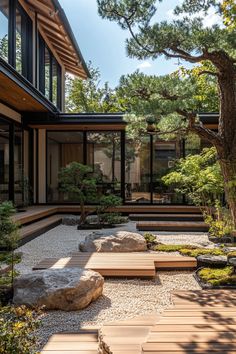 a very nice looking house with some rocks and trees