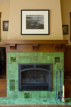 a fireplace in a living room with green tile