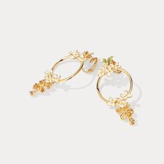 Crafted from enamel and delicately infused with the scent of Osmanthus Fragrans, these enchanting earrings evoke the beauty of luxury and elegance. Perfect for any special occasion, these exceptional earrings will bring a delightful scent and timeless sophistication to any outfit. DETAILS Plating: 18K Gold Materials: 18K Gold on Brass, Enamel, Silver Size:  2.05"*0.98"(52mm*25mm) Weight:  6.6 g/pr Hypoallergenic design Gold Earrings With Flower Charm In Enamel, Gold Earrings With Flower Charm And Enamel, Gold Enamel Earrings With Flower Charm, Elegant Green Enamel Flower Earrings, Gold Enamel Dangle Hoop Earrings, Gold Enamel Flower Earrings For Wedding, Osmanthus Fragrans, Poppy Necklace, Oranges Gift