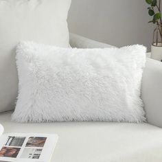 a white pillow sitting on top of a couch