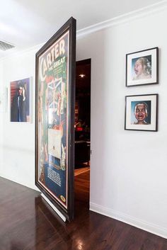 an open door leading into a room with pictures on the wall and wood flooring