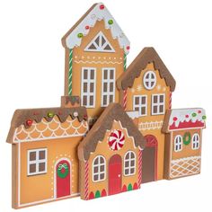 three gingerbread houses with candy canes on the roof