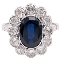 an oval blue sapphire and diamond cluster ring, by van cleef & co