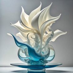 a glass vase sitting on top of a blue plate