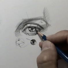 someone is drawing an eye with a pencil