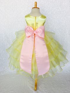 Beautiful organza ruffled dress tailor-made and ready to impress at any upscale event! Handcrafted with the upmost of care and attention to detail, we make sure that each dress is perfectly one of a kind for your little girl. Bridal satin top followed by a satin sash for a nice and snug fit Comes with a flower and matching colored sash. The skirt has layers of cut organza strips which are sewn onto the lining to create the ruffled effect The organza is then sewn at the edges to create those cris Spring Birthday Princess Dress In Organza, Ruffled Princess Dress For Wedding And Easter, Fitted Organza Princess Dress For Birthday, Princess Dress With Ruffles For Wedding Easter, Princess Dress With Ruffles For Wedding And Easter, Pink Party Dresses With Sashes, Easter Princess Dress With Ruffles For Party, Easter Party Princess Dress With Ruffles, Multicolor Ruffled Tutu Dress For Wedding