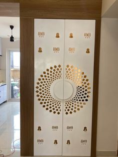 a white door with gold designs on it in a kitchen next to a stove top oven