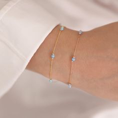 Enhance your look with this 14k Gold Light Blue Opal Round Bracelet, which comes in three opal colors: immaculate white opal, peaceful light blue opal, and intriguing dark blue opal. Each opal represents October's birthstone and possesses distinct characteristics, making this bracelet an ideal birthday gift or accessory for Libras.  This bracelet oozes elegance and grace because to its link to Venus, the goddess of love and beauty. Choose the light blue opal for a quiet and soothing impression, Blue Birthstone Bracelets In Fine Jewelry Style, Blue Birthstone Bracelets Fine Jewelry, Light Blue Gemstone Bracelets As Gift, Minimalist Blue Jubilee Bracelet, Blue Minimalist Jubilee Bracelet, Blue Dainty Birthstone Bracelets, Dainty Blue Gemstone Beaded Bracelets, Fine Jewelry Blue Bracelets, Blue Dainty Gemstone Beaded Bracelet