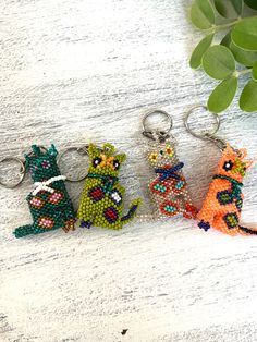 four beaded cats sitting next to each other