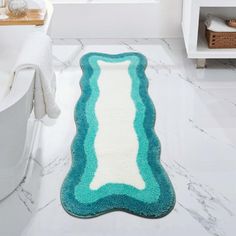 a bathroom with a bathtub and rug in it