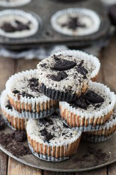 chocolate cupcakes with oreo crust on a plate next to an old muffin tin